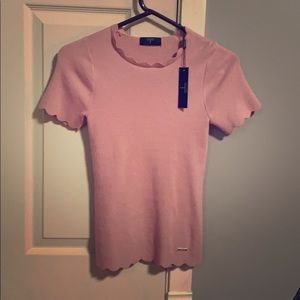A pink sweater with short sleeves